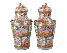 Load image into Gallery viewer, A pair of Chinese Famille Rose porcelain ginger jars with gold-colored handles and lids, featuring detailed multicolor scenes of figures in traditional attire. 