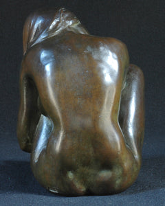 Bronze sculpture of a seated woman, Signed