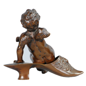 Bronze Putti sitting on a Persian Slipper, France, c.1875