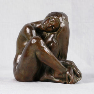 Bronze sculpture of a seated woman, Signed
